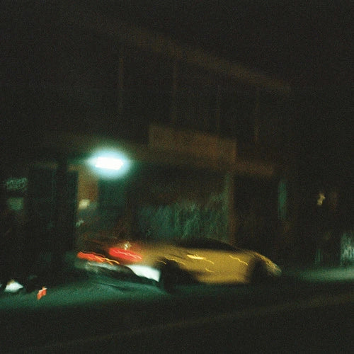 Cover art for "Like We Wrote" by Lithe. Blurred image of a car at night in front of a building, capturing the artist's mysterious and ethereal aesthetic. Released 2024.