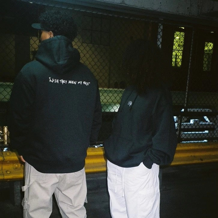 Two people wearing green Lithe hoodies with "wish they seen my face" text. One hoodie shown from the back and the other from the front. Created after the popular single. Released in 2022.